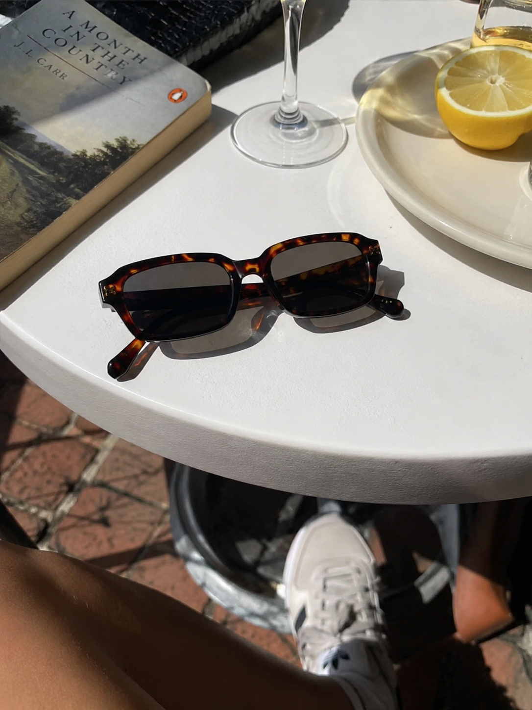 Tortoise Mareframes on a sunlit café table